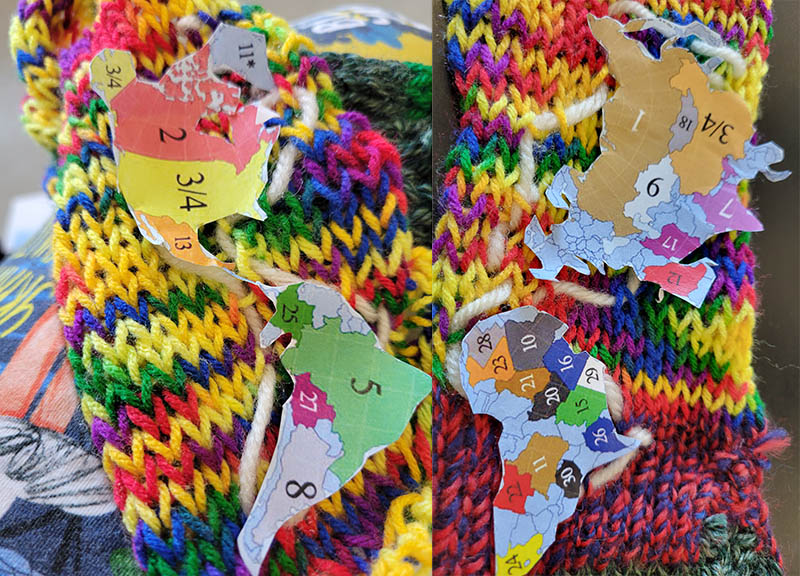 Cut out Dymaxion projection world map pieces and attempting to embroider around them